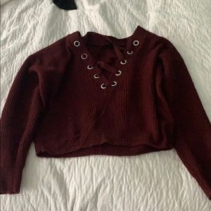 maroon sweater with cross ties in the front